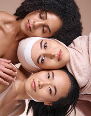 Portrait, beauty and diversity with woman friends in studio on a brown background for skincare or inclusion. Face, pile and natural with a model female friend group posing to promote equality