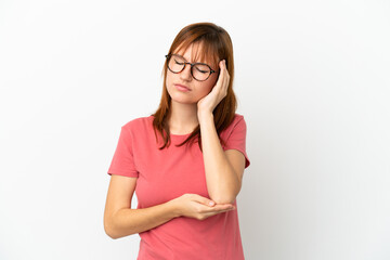 Redhead girl isolated on white background with headache