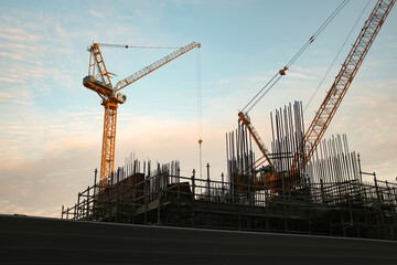 construction site with crane at sunset. Beautiful colorful sky