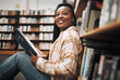 © Kay A/peopleimages.com - University, education and black woman in library reading book. College scholarship, student and happy female learner thinking about studying, knowledge and learning while sitting by bookshelf or case