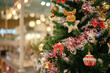 © galaganov - New Year's and Christmas. A toy deer hangs on a decorated Christmas tree.
