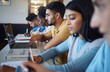 © K Abrahams/peopleimages.com - Students, diversity and laptop books in classroom, lesson and library study for education, research and learning. School group, college people and university technology on global scholarship campus