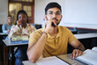 © K Abrahams/peopleimages.com - Arab man, university student and studying law for a class project with legal paper, contract documents and file of information for research homework. College education, law seminar and studying goals
