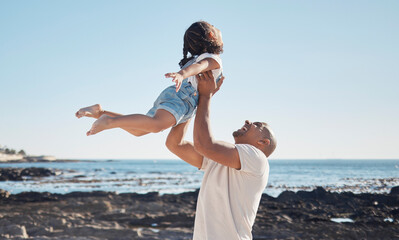 Wall Mural - Beach, man holding girl in air and playful for vacation, summer and weekend break. Father swing daughter, relax and bonding at seaside, holiday and loving together for quality time, outdoor and smile