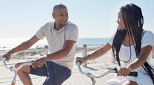 Couple, Bike And Beach For Fun Bonding In A Happy, Loving Relationship In Cape Town, Sea Point. Cycling, Fitness And Bond With A Man And Woman Riding Bicycles By The Seaside Or Ocean In Summer
