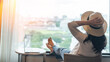 © Chinnapong - Work-Life balance, life quality, work from home and travel concept with business woman relaxing, take it easy, resting in  hotel resort, condominium, or apartment luxury living room with notebook