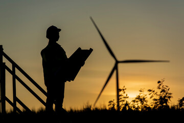 Wall Mural - silhouette of a person with Wind turbine. silhouette of a person