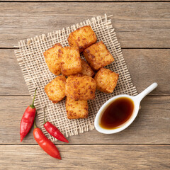 Wall Mural - Tapioca dice, typical northeast brazilian food with chilli pepper syrup over wooden table