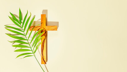 palm sunday holiday. wooden cross with palm leaf on light background with copy space. religion backg