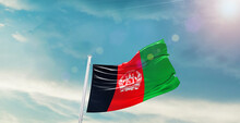 Waving Flag Of Afghanistan In Blue Sky. The Symbol Of The State On Wavy Cotton Fabric.