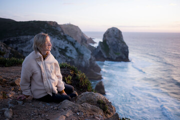 Poster - A woman on the rocks on the Sintra, Portugal.