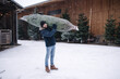 © Aleksandr - Delivery of Christmas tree from green shop market of eco trees. Fir tree packaging and delivery. Man carries fir tree