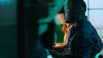 Black man, woman or computer in night office for web design branding, ux logo programming or digital marketing deadline. Creative designer, teamwork or collaboration on technology in coworking space