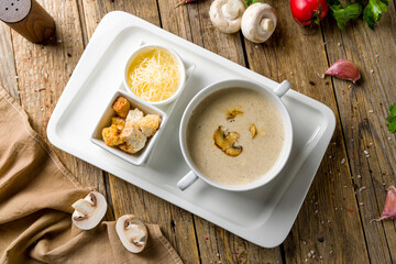 Poster - Cream soup of mushrooms on wooden table top view