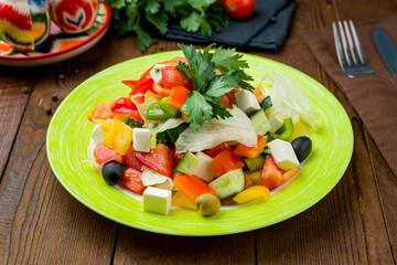 Poster - Greek salad with feta and fresh vegetables on wooden table