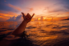 Shaka Symbol With Bright Sunset In Ocean. Lifestyle Surfing Concept