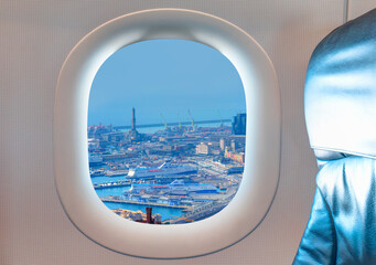 Wall Mural - Aerial view old town and harbor of Genoa as seen through window of an commerical passenger airplane   
, Italy