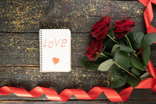 Red Roses With Ribbon On Wooden Background. Valentines Day Background
