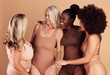 © David L/peopleimages.com - Diversity, beauty and group of women in lingerie in studio isolated on a brown background. Underwear, self love and body positivity, empowerment and confident happy friends with different body types.