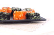 different types of Maki sushi on a black plate