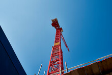 Red Crane Machinery Under Blue Sky