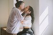 © Westend61 - Romantic hipster couple kissing in front of wall