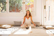 © Westend61 - Smiling spiritual woman with rin gong and healing crystal at home