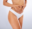 © Wesley J/peopleimages.com - Fitness, underwear and heart hand of woman for wellness, digestion and lose weight body campaign. Self care, aesthetic and healthy gut of diet model on white studio background touching stomach.