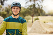 © Clement C/peopleimages.com - Happy man, nature and sports helmet for cycling outdoor for mountain bike training fitness, exercise and workout for travel and freedom. Portrait of athlete male ready for marathon with safety gear