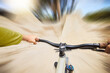 © Clement C/peopleimages.com - Pov hands, speed and cycling with bike and travel on nature path for outdoor exercise, training workout or race. Freedom, sports adventure and bicycle cyclist on fast journey for fitness workout blur