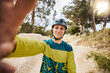 © Clement C/peopleimages.com - Happy, cycling and man selfie on nature trail with cheerful smile for adventure, journey and healthy lifestyle. Fitness, happiness and exercise guy photograph on cycle path in Vancouver, Canada.
