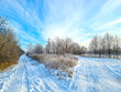 Winter landscape: two roads in the snow against the blue sky. Beautiful nature.
