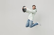 © ViDi Studio - Full body young side view happy satisfied man wear mint hoody look camera hold steering wheel driving car jump high isolated on plain solid white background studio portrait. People lifestyle concept.