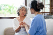 © bongkarn - An elderly woman is reassured by a doctor. holding an aged female's hands to comfort