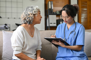 Wall Mural - Stressed and worried Asian elderly female patient discussing medical checkup's result with doctor