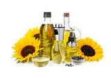 Fototapeta Zwierzęta - Bottles with cooking oil, sunflowers and seeds on white background