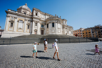 Wall Mural - Family tourists walk near Basilica di Santa Maria Maggiore in Rome, Italy.
