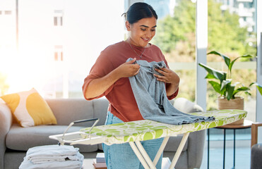 Wall Mural - Woman, laundry and ironing board, cleaning service and domestic worker with happy, smile and working in home. Happiness female, cleaner and housework with clothing, clothes and hygiene in house