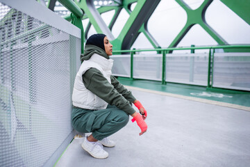 Poster - Young muslim woman having break during morning jogging.