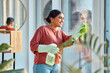 © Jordan C/peopleimages.com - Woman, cleaning and window st home for dirt, dust and bacteria with a cloth and spray bottle for shine and clean view. Happy female cleaner or maid with a smile using chemical on apartment glass