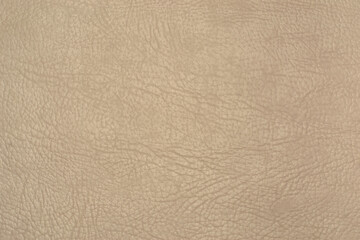 The texture and background of the leatherette is beige. Leatherette pattern texture as background and design element. Leather background for design development