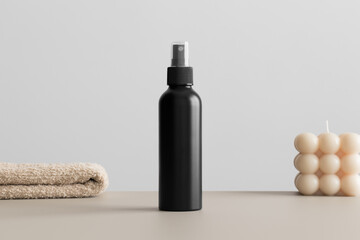 Canvas Print - Black cosmetic spray bottle mockup with a candle and a towel on the beige table.