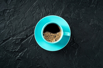 Poster - Coffee cup, overhead flat lay shot on a black slate background with a place for text, espresso drink in a vibrant blue mug