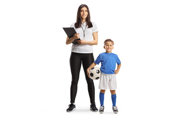 Wall Mural - Boy with a football standing next to a female sports coach