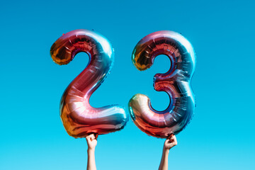 Poster - showing two balloons forming the number 23