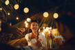 Happy Asian woman have fun with firework sparklers with her friends in festival celebrating at night party outdoor. Friendship and new year celebration concept.