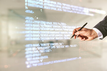 Wall Mural - double exposure of male hand with pen working with abstract programming language interface on blurre