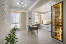 A Sophisticated White Studio Apartment With A Kitchen Tand Dining Table