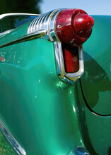 Closeup Detail Of A Red Taillight And Fender Of A Green Classic Car