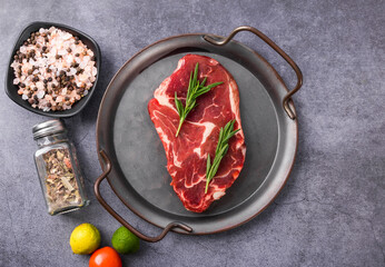 Wall Mural - Fresh beef steak on a concrete background